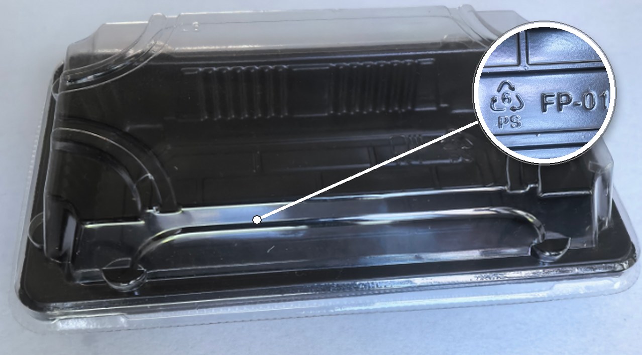 Custom embossed logo detail on a black PS tray