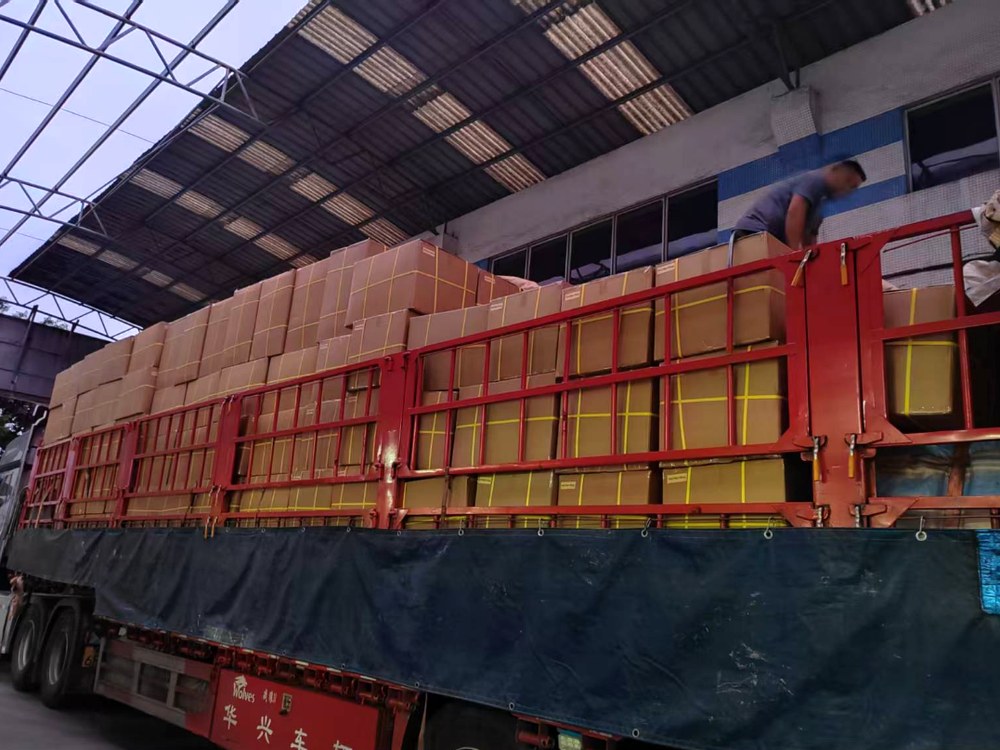 Partner flatbed truck fully loaded with boxed products at the factory